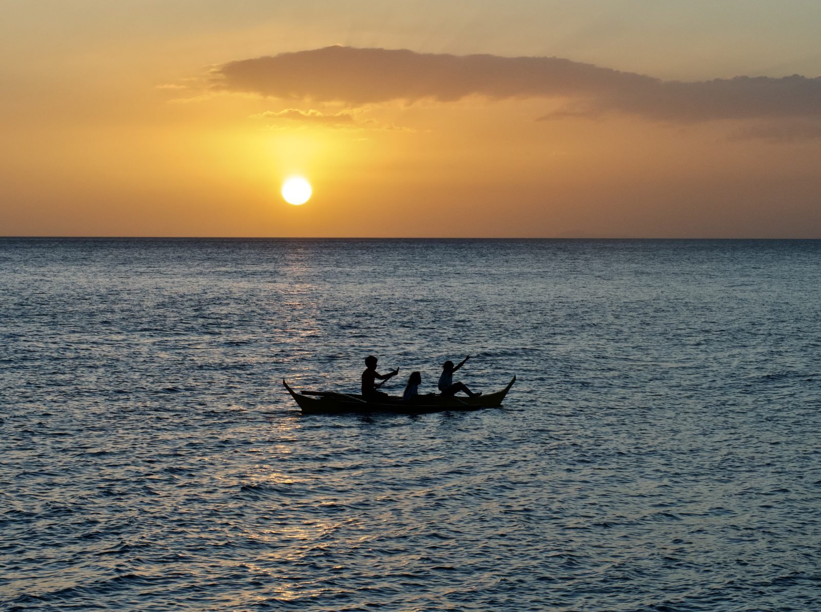 Sunset silhouette of a bangka on Balayan Bay, Anilao