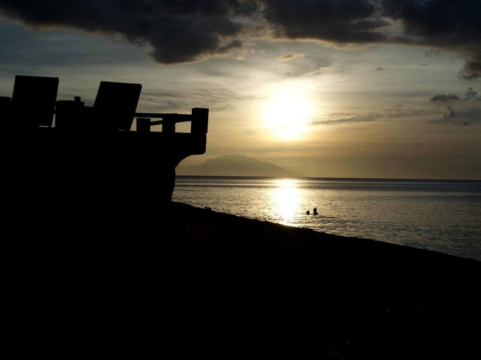 Sunset swimmers at Blue Ribbon Divers with Maricaban Island